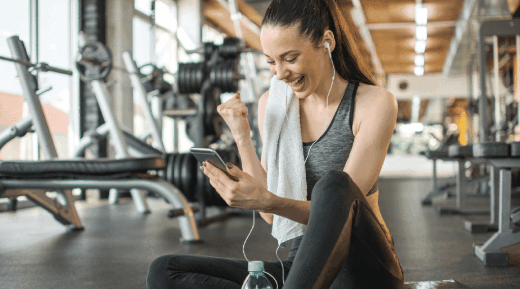 Woman Working Out at Gym on Phone