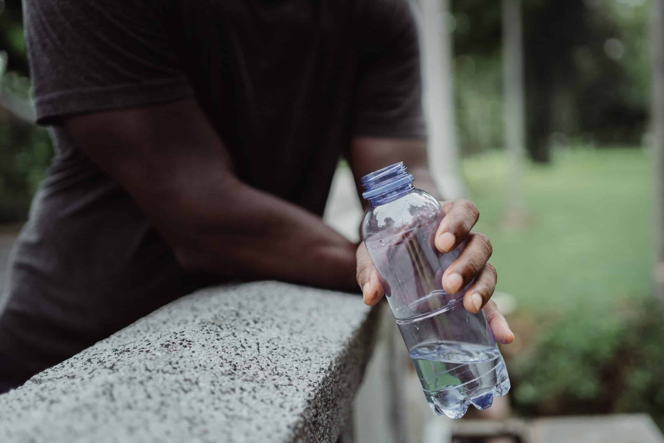 Hand Holding Water Bottle Outside