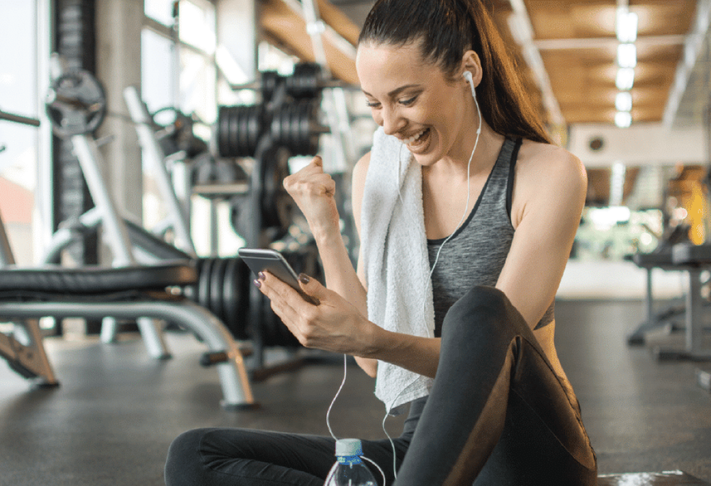 Woman Working Out at Gym on Phone